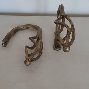 Pair of metal curtain tiebacks.